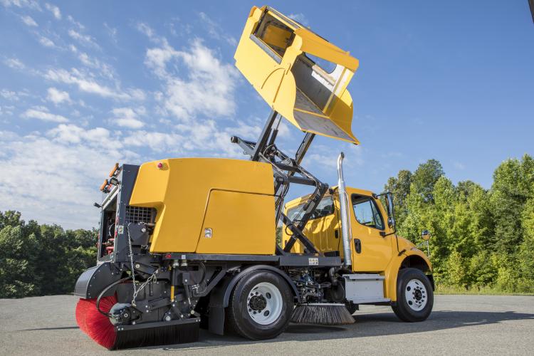 E35m yellow truck mounted street sweeper hopper raised and tilted