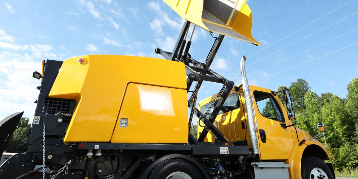 E35m yellow mechanical truck mounted sweeper hopper raised close up E35m yellow mechanical truck mounted sweeper hopper raised close up
