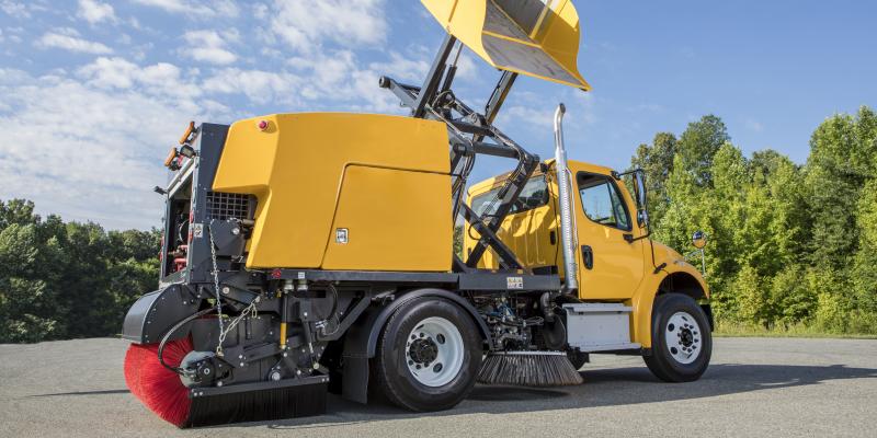 E35m yellow truck mounted street sweeper hopper raised and tilted